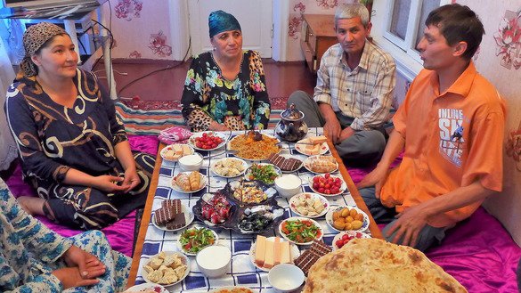 The Mannonovs gather at 8pm for the evening meal, iftar. Traditionally, they lay out a generous spread after sundown to regain their strength. They face another 17 hours without food or drink the next day. [Nadin Bahrom]