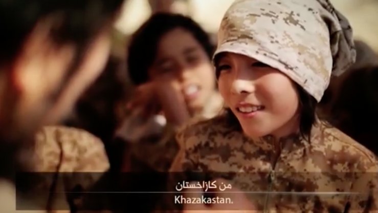 A screen shot from an 'Islamic State' propaganda video shows a boy from Kazakhstan being trained to use an assortment of guns.