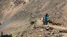 Kuchli sel tufayli piyodalar so‘qmoqlari yuvilib ketganidan so‘ng, Barsem qishlog‘i aholisi tik va xavfli qiyalik bo‘ylab harakatlanmoqda. (Jahon Banki guruhi)
