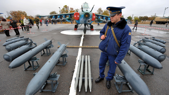 2013-yil 27-oktabr kuni Qirg‘izistondagi Qand shahrida joylashgan Rossiya harbiy aviabazasining 10 yilligi munosabati bilan o‘tkazilgan ko‘rgazmada rossiyalik askar SU-25 jangovar samolyotini qo‘riqlamoqda. Qand Bishkekdan 20 kilometr masofada joylashgan. (Vyacheslav Oseledko/AFP)