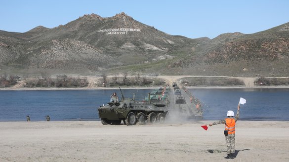 Kazakh forces demonstrate for Defence Minister Nurlan Yermekbayev joint operations in the assault crossing of a water obstacle and in a bridge laying in Almaty Province April 12. [Kazakh Ministry of Defence]