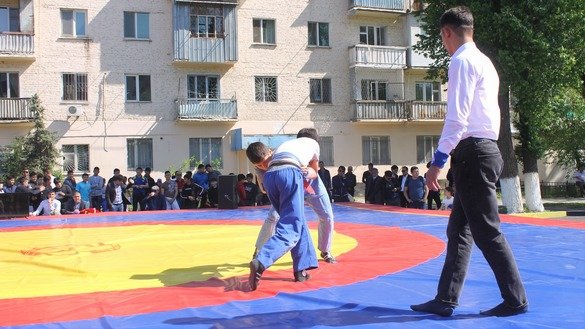 Young men wrestle May 1 in Taraz as part of People's Unity Day. [Aydar Ashimov]