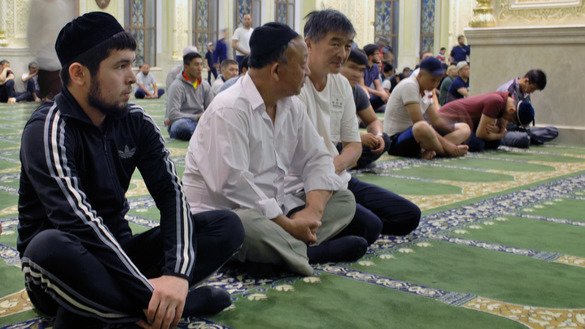 Muslims await a call to evening prayer. [Maksat Osmonaliyev]