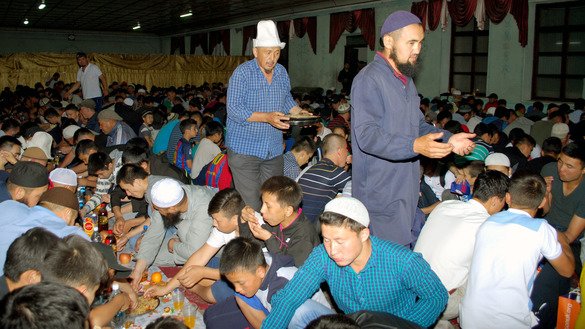 Muslims enjoy iftar together. In the spirit of charity, some Muslims pay for the cost of a group iftar. [Maksat Osmonaliyev]
