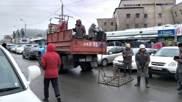Utility workers are shown in Bishkek January 9. Kyrgyzstan January 1 enacted laws to stiffen punishments for littering and other quality-of-life violations. [Bishkek City Hall]