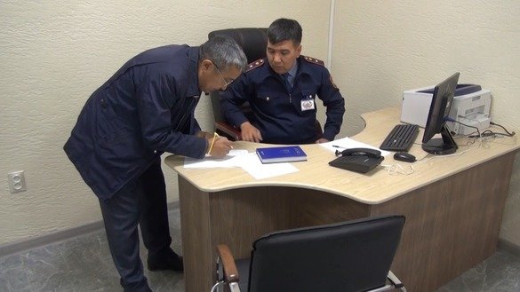 An officer assists a visitor at a police service centre in Taraz on January 16, 2019. [Aydar Ashimov]