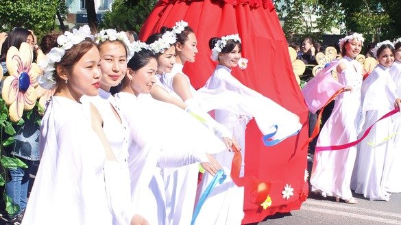 Girls in snow-white robes perform a dance with multi-coloured ribbons in downtown Taraz May 1 for People's Unity Day. [Aydar Ashimov]