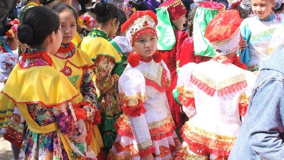 Girls wearing folk dresses gather May 1 in Taraz for People's Unity Day. [Aydar Ashimov]