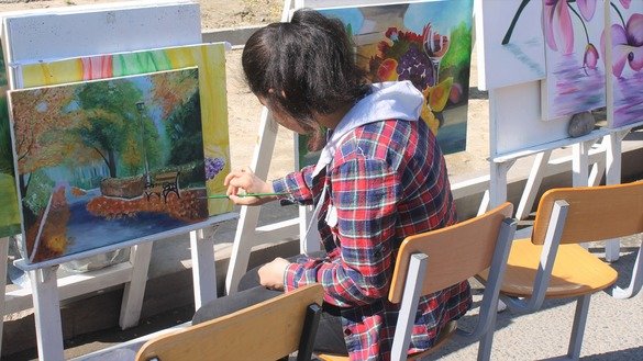 Artists finish their paintings at a square in Taraz on May 1 for People's Unity Day. [Aydar Ashimov]