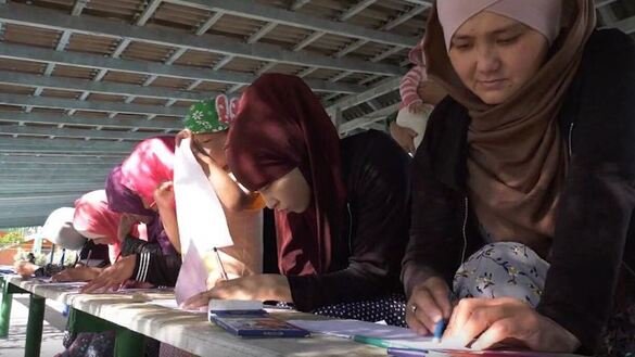 Women who have returned from Syria paint at a rehabilitation centre in Mangystau Province, Kazakhstan. The screenshot is from a KNB video.