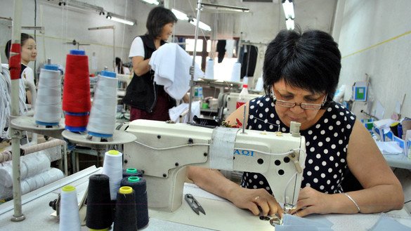 A seamstress sews women's pants in Bishkek on June 1. The factory employed 10 seamstresses, but they were furloughed for about two months, according to the owner. [Maksat Osmonaliyev]