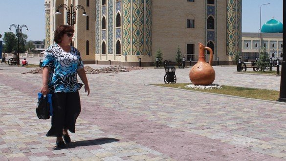 A woman walks outdoors in Taraz on May 29. Though Kazakhstan has lifted all restrictions on movement, few Kazakhs venture outside. [Aydar Ashimov]