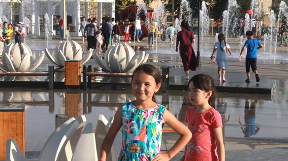 Girls stroll near fountains in Turkistan, Kazakhstan, on June 7. [Aydar Ashimov]