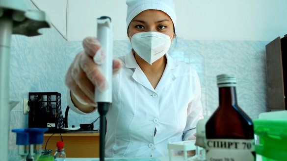 Jyldyz Turdaliyeva, a lab technician at the Republican (National) Blood Centre in Bishkek, on August 14 uses a dosing device to collect serum to check whether brucellosis, a bacterial infection, is present in a patient's blood. Blood from donors at the centre undergoes a full lab work-up.  [Maksat Osmonaliyev]
