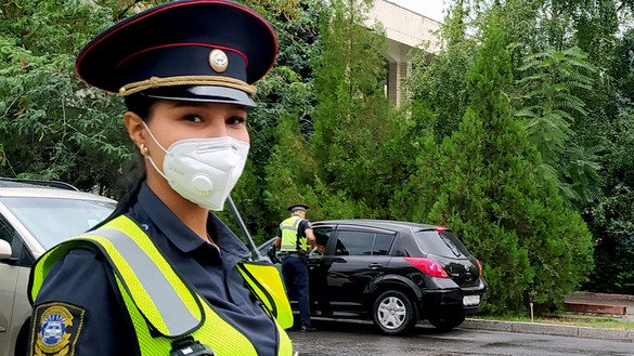 Perizat, a senior police inspector, wears a protective mask as she works to ensure traffic safety on August 13 in Bishkek. [Maksat Osmonaliyev]