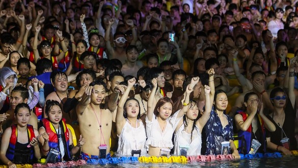 Thousands of party-goers in Wuhan, China, on August 15 crowd together without concern over the coronavirus. [STR/AFP]