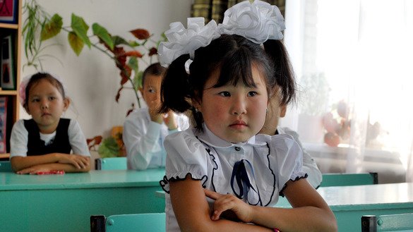 A pupil listens attentively to her teacher. September 1, K. Ibraimaliyev School, Kurpuldok village, Panfilov District, Chui Province. [Maksat Osmonaliyev]