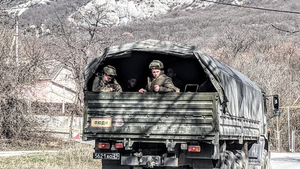 Russian troops ride in a military vehicle near a base in the village of Kiziltash on March 5. Before the annexation of Russia, the Ukrainian Tiger special force regiment was based here. [Yevgenij Gordienko/Caravanserai]