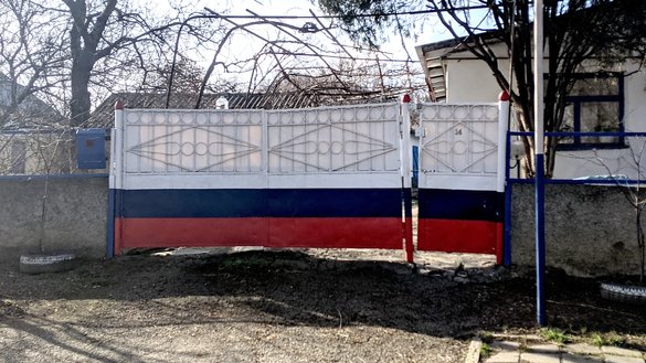 After Russia's annexation of the Crimea, some residents began painting fences with the Russian tricolour. This gateway displaying the Russian colours was photographed in Kiziltash village on March 5. [Yevgenij Gordienko/Caravanserai]