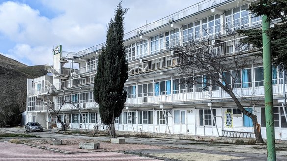 The Priboy recreation centre in Koktebel village, seen here on February 26, is up for sale. It used to be a popular destination, but has stood empty since 2014. A beautiful beach once favoured by locals and tourists runs along the front of the complex. [Yevgenij Gordienko/Caravanserai]