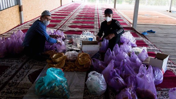 Workers lay out parcels of food meant for fasting Muslims and for the needy during the holy month of Ramadan, paid for by donors, at the Kelechek mosque in Bishkek on April 27. [Maksat Osmonaliyev/Caravanserai]