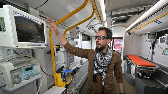 Romanian volunteer Radu Hossu shows inside of an armoured vehicle for medical use at a workshop in Kyiv's outskirts on May 1. [Sergei Supinsky/AFP]