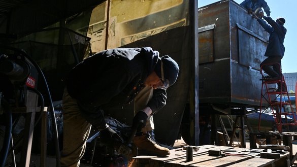 Workers build an armoured vehicle for medical use at a workshop in Kyiv's outskirts on May 1. [Sergei Supinsky/AFP]