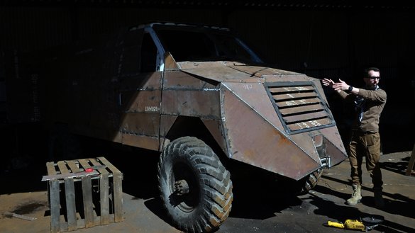 Romanian volunteer Radu Hossu shows an armoured vehicle for medical use at a workshop in Kyiv's outskirts on May 1. [Sergei Supinsky/AFP]