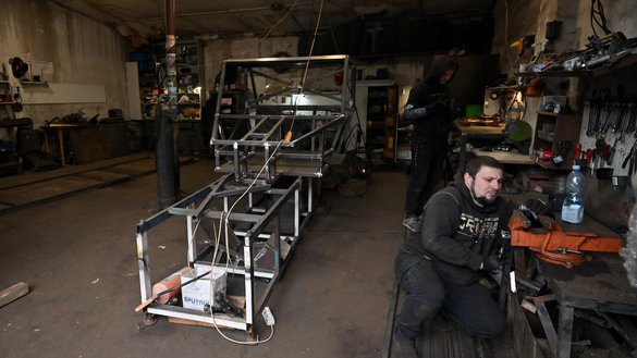 Workers build a buggy in Dracarys' workshop at an industrial site in Ukrainian capital of Kyiv on April 27. [Sergei Supinsky/AFP]