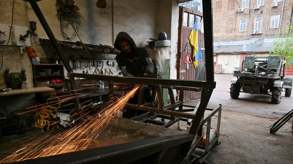 A worker grinds a buggy in Dracarys' workshop at an industrial site in Ukrainian capital of Kyiv on April 27. [Sergei Supinsky/AFP]