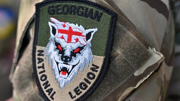 A patch bearing the emblem of the Georgian National Legion is seen on a uniform during a presentation organised by Swiss NGO Geneva Call in Kyiv on June 30, 2022. [Sergei Supinsky/AFP]